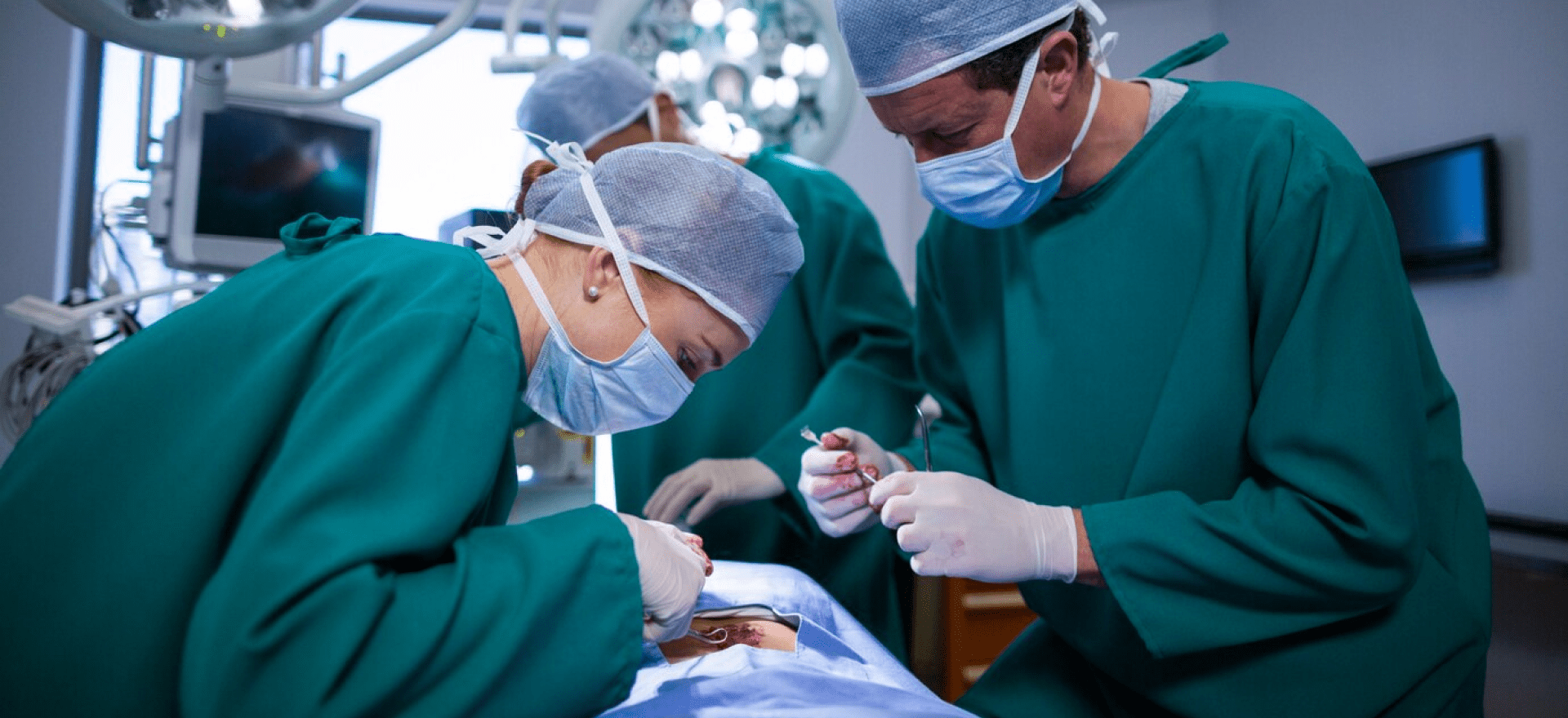 Doctors performing general surgery in the operation theatre with advanced medical equipment and sterile environment.