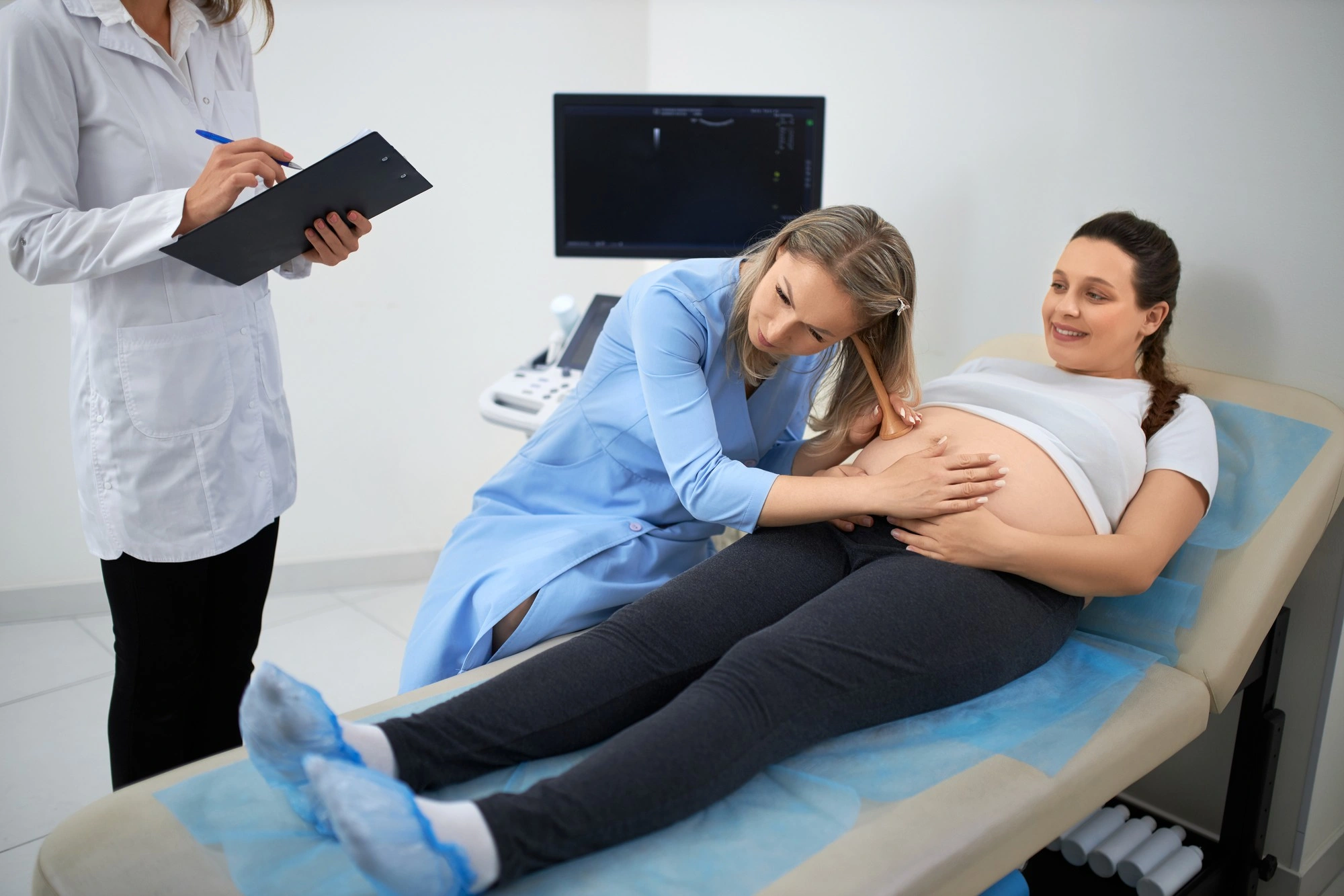 Gynecologist Examining Pregnant Woman with a stethoscope